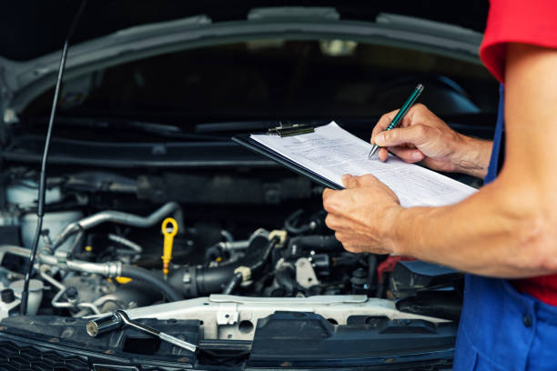 A mechanic is inspecting a car's engine
