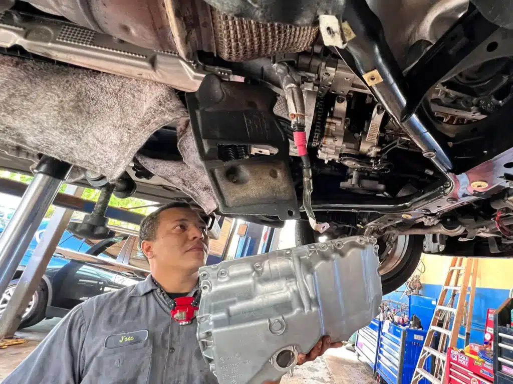 Mechanic checking oil leak on Audi in Hollywood FL