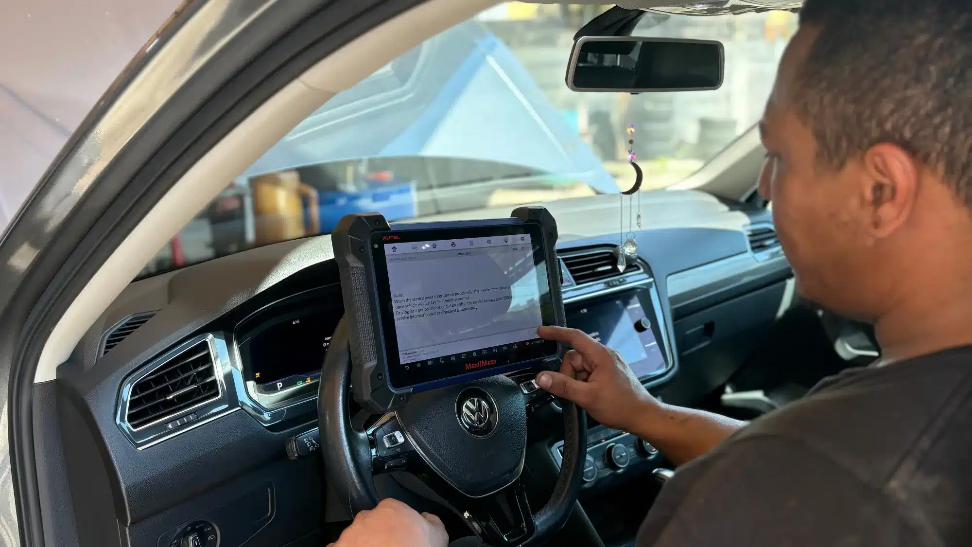 Professional technician performing Mercedes Benz repair using factory diagnostic equipment in Hollywood, FL.